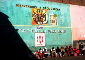 The mural reads: Welcome to the football pitch... Freedom and justice for everyone. 