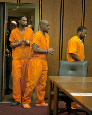 three defendants enter the court room