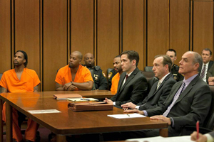 three defendants and their defense team in court