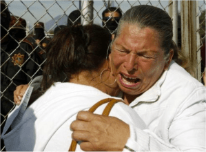 Family members mourn the loss of inmates killed in prison riot where 44 were left dead. 